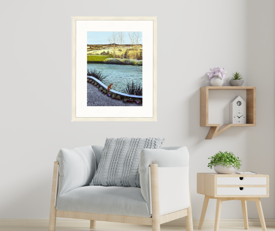 Framed landscape print on a wall of a featuring a fox overlooking a wintery garden with distant trees and fields