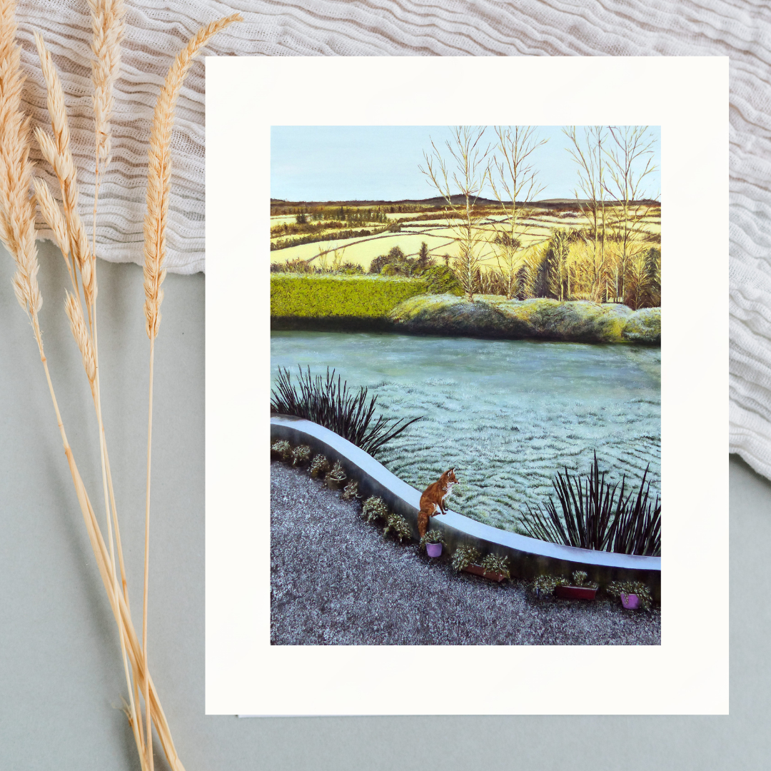 Mounted print of a scenic landscape featuring a fox overlooking a wintery garden with distant trees and fields